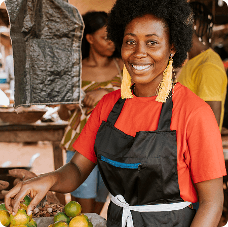 Merchant smiling at a market stall